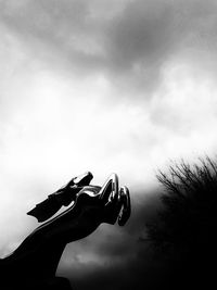 Low angle view of silhouette woman against sky