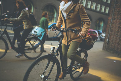 Women riding bicycles on street
