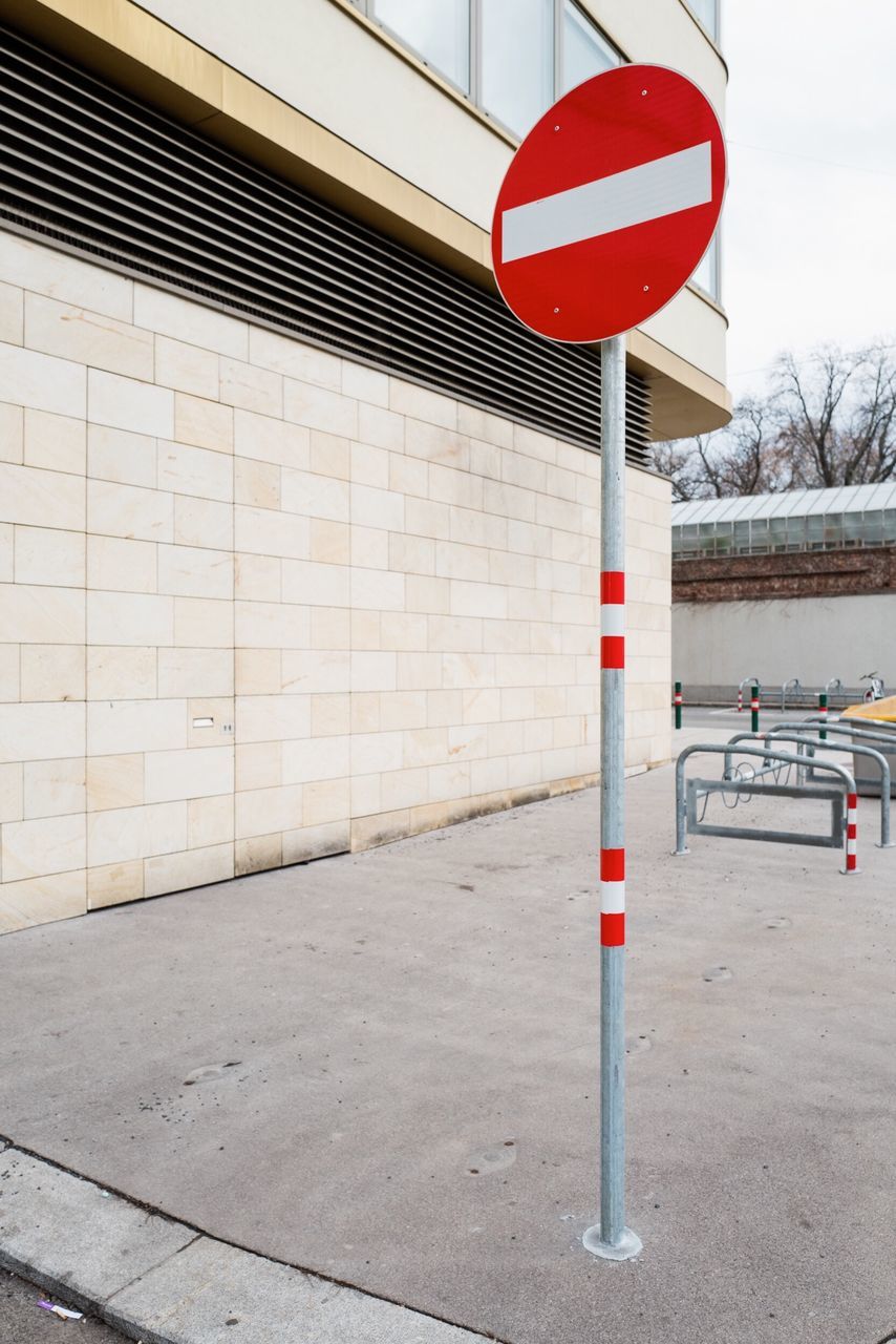 sign, communication, architecture, red, built structure, day, road, road sign, wall - building feature, guidance, no people, outdoors, transportation, information, wall, building exterior, nature, footpath, information sign, text, road warning sign