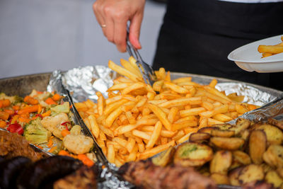 Close-up of hand holding french fries