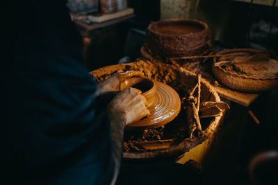 Close up man working with clay