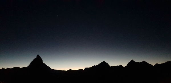 Silhouette of mountain against sky at sunset