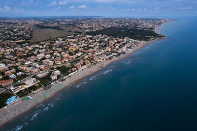 Aerial high angle view of sea and town, lavinio mare, italy 