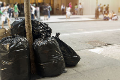 Garbage on sidewalk by street in city