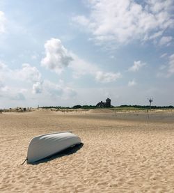 Sand dune on beach against sky