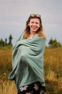 Portrait of a smiling young woman on field