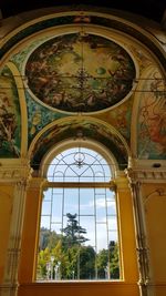 Low angle view of ornate glass window in building