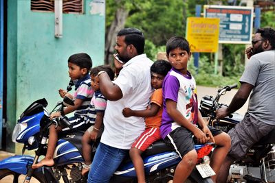 Group of people sitting on bicycle