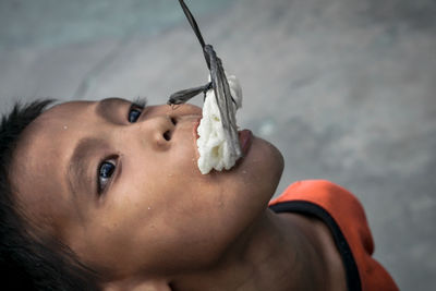 Close-up portrait of boy eating food