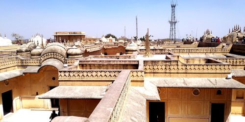 Buildings in city against clear sky