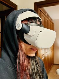 Midsection of woman wearing virtual reality headset