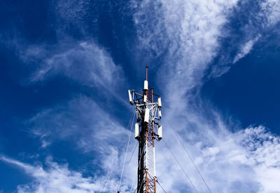 Low angle view of communications tower against sky