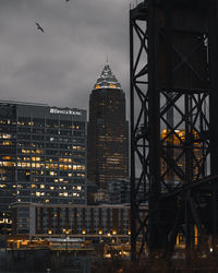 View of modern buildings against cloudy sky