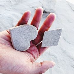 Cropped hand of person holding stone
