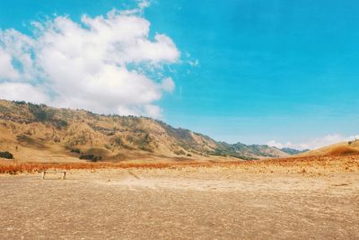 Scenic view of arid landscape against sky