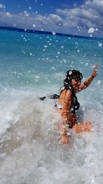 Woman enjoying on shore at beach
