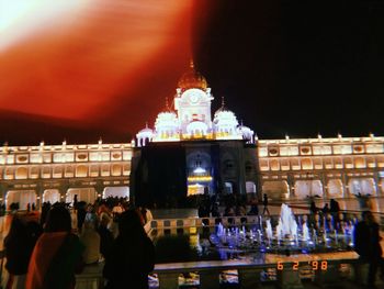 Group of people in illuminated building at night