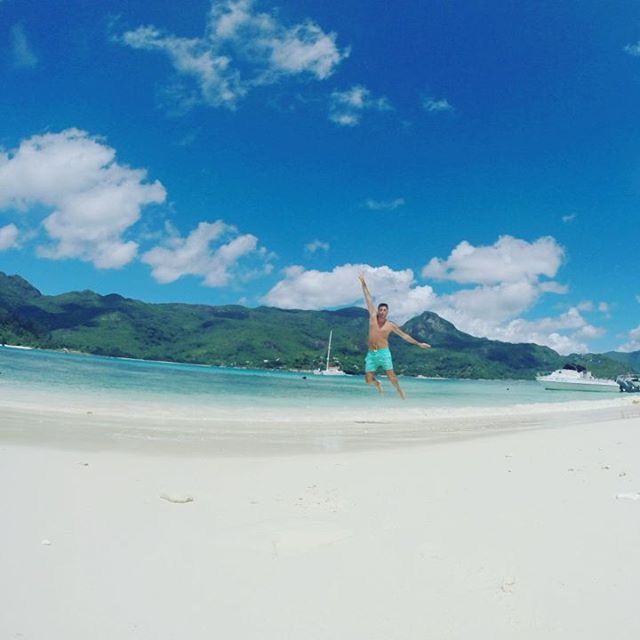 beach, sand, leisure activity, lifestyles, water, sky, sea, full length, shore, vacations, casual clothing, mountain, rear view, tranquil scene, tranquility, scenics, beauty in nature, blue