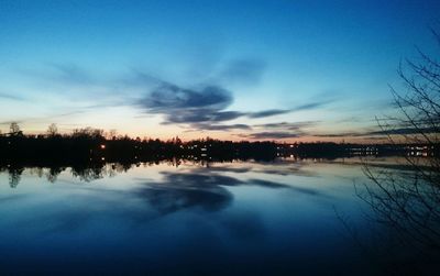 Reflection of clouds in sea at sunset