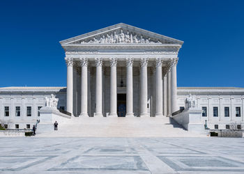 Low angle view of historical building against blue sky