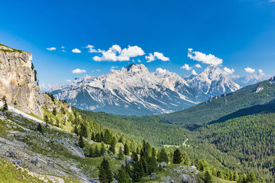 Scenic view of mountains against blue sky