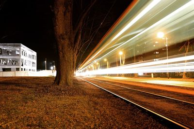 Light trails on railroad tracks at night