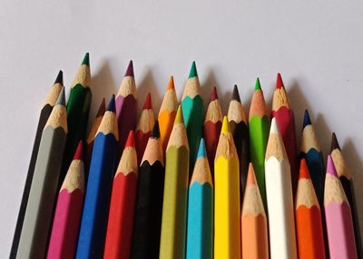 Close-up of colored pencils against white background