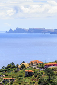 High angle view of buildings by sea against sky