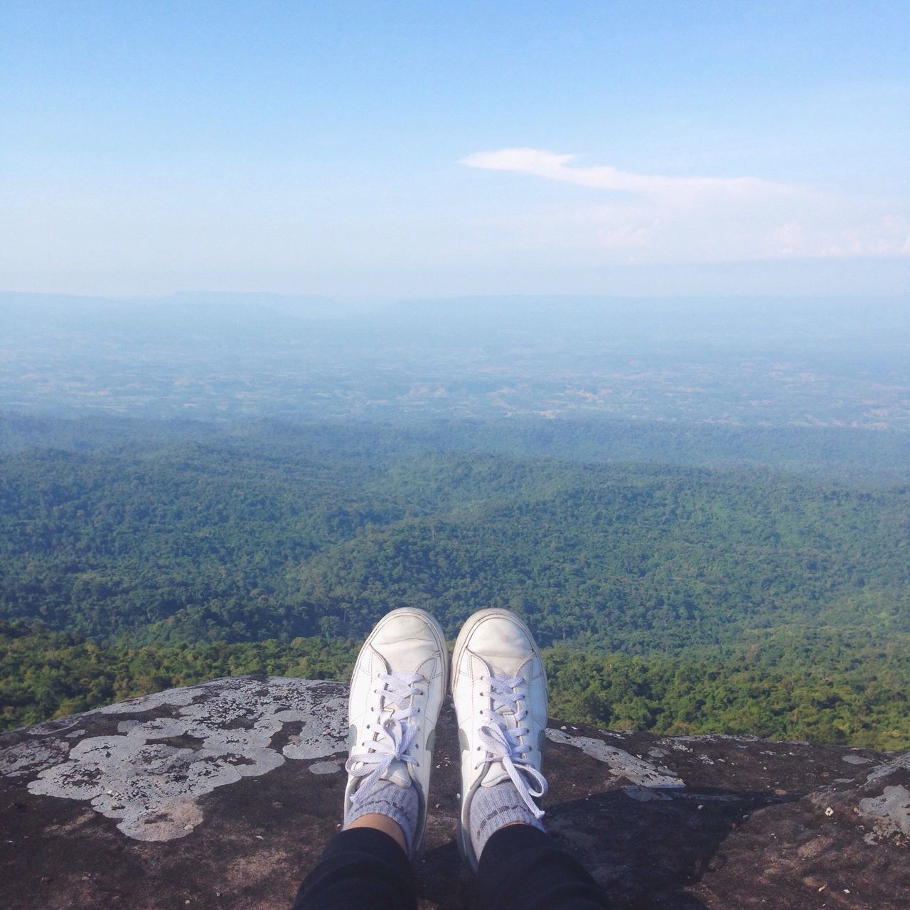 low section, tranquil scene, standing, tranquility, lifestyles, person, scenics, personal perspective, landscape, mountain, leisure activity, shoe, beauty in nature, men, nature, sky, water, idyllic