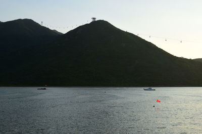 Scenic view of sea and mountains against sky