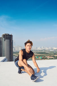 Young man and woman against buildings in city