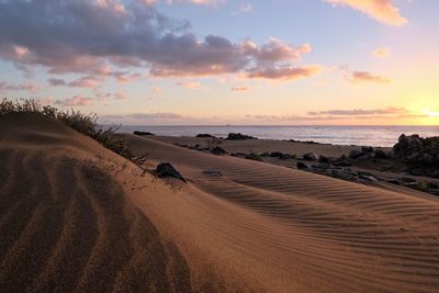 Scenic view of beach against sky during sunset