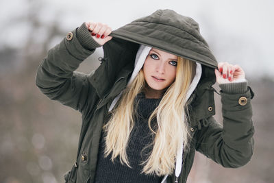 Portrait of beautiful young woman wearing hooded jacket