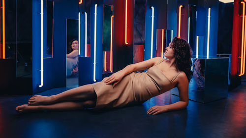 Side view of woman sitting on stage