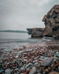 Rocks on beach against sky