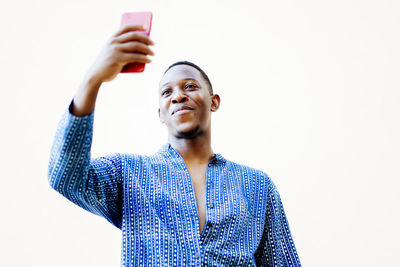 Young african man making a selfie with his smartphone