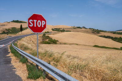 Stop road sign on hill of tuscany italy