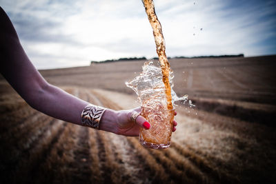 Cropped hand of woman holding water