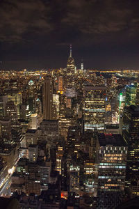 High angle view of city lit up at night