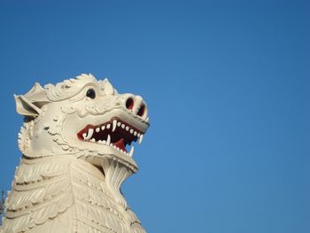 Low angle view of built structure against clear blue sky