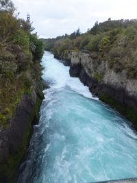 Scenic view of river flowing through rocks