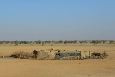 Scenic view of desert against clear blue sky