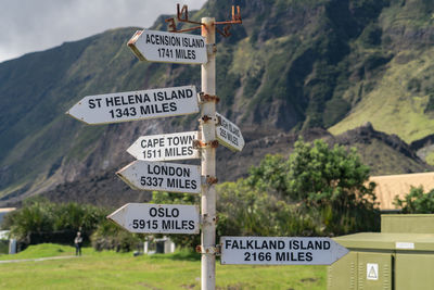 Information sign against mountain road