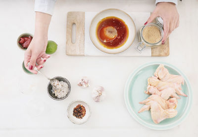 High angle view of woman holding food on table