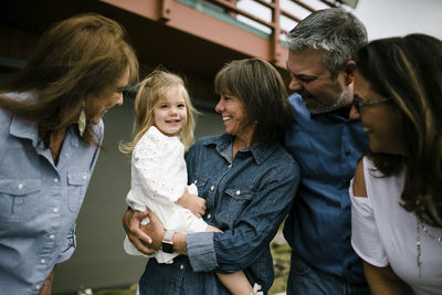 Happy family with baby girl standing at tourist resort