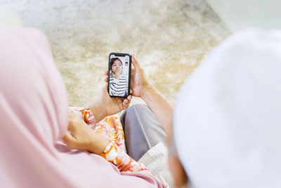 Midsection of woman using mobile phone