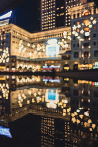 Low angle view of illuminated buildings in city at night