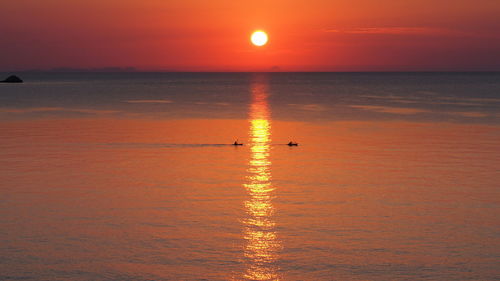 Scenic view of sea against orange sky