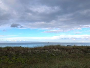 Scenic view of sea against cloudy sky