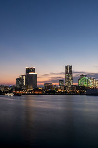 Minato mirai skyline during the sunset with the reflection in the sea. long exposure. golden hour